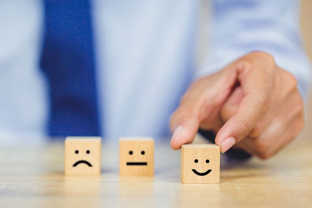 Customer,Pressing,Smiley,Face,Emoticon,On,Wood,Cube,,Service,Rating,